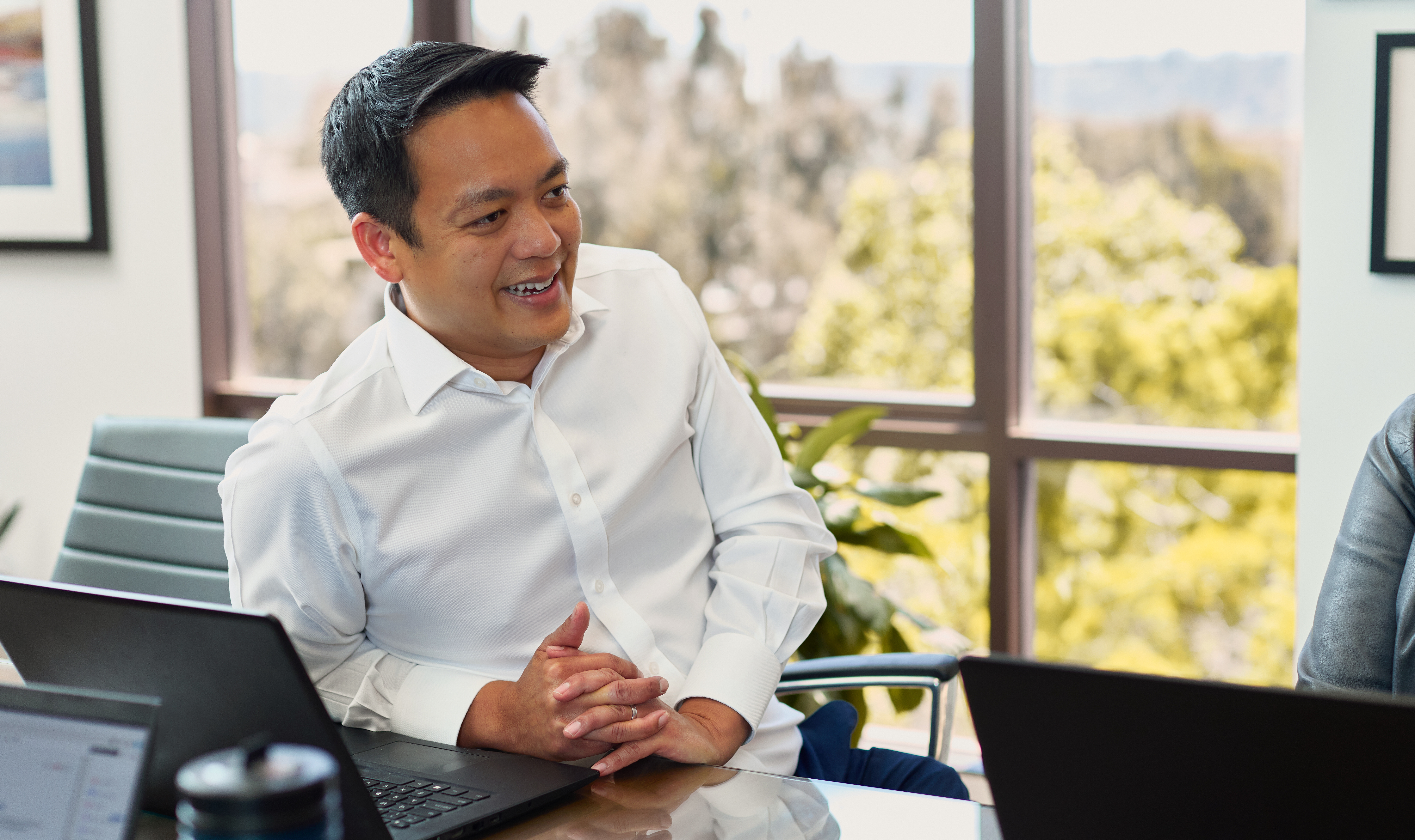 An employee smiles in an office. 