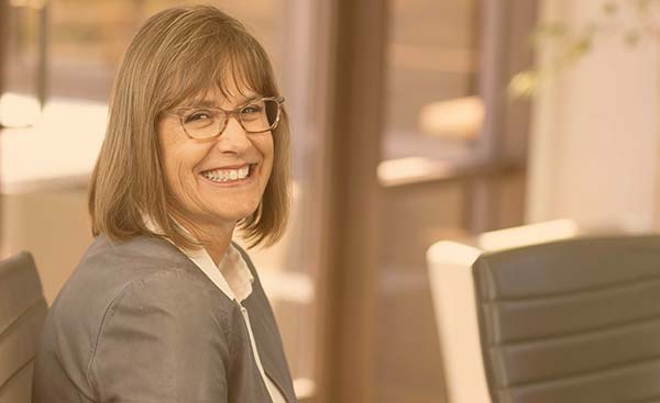 A woman smiling in an office.