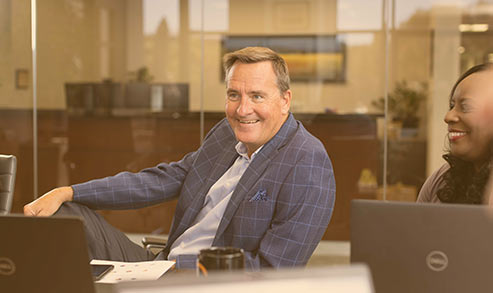 A smiling man in an office. 