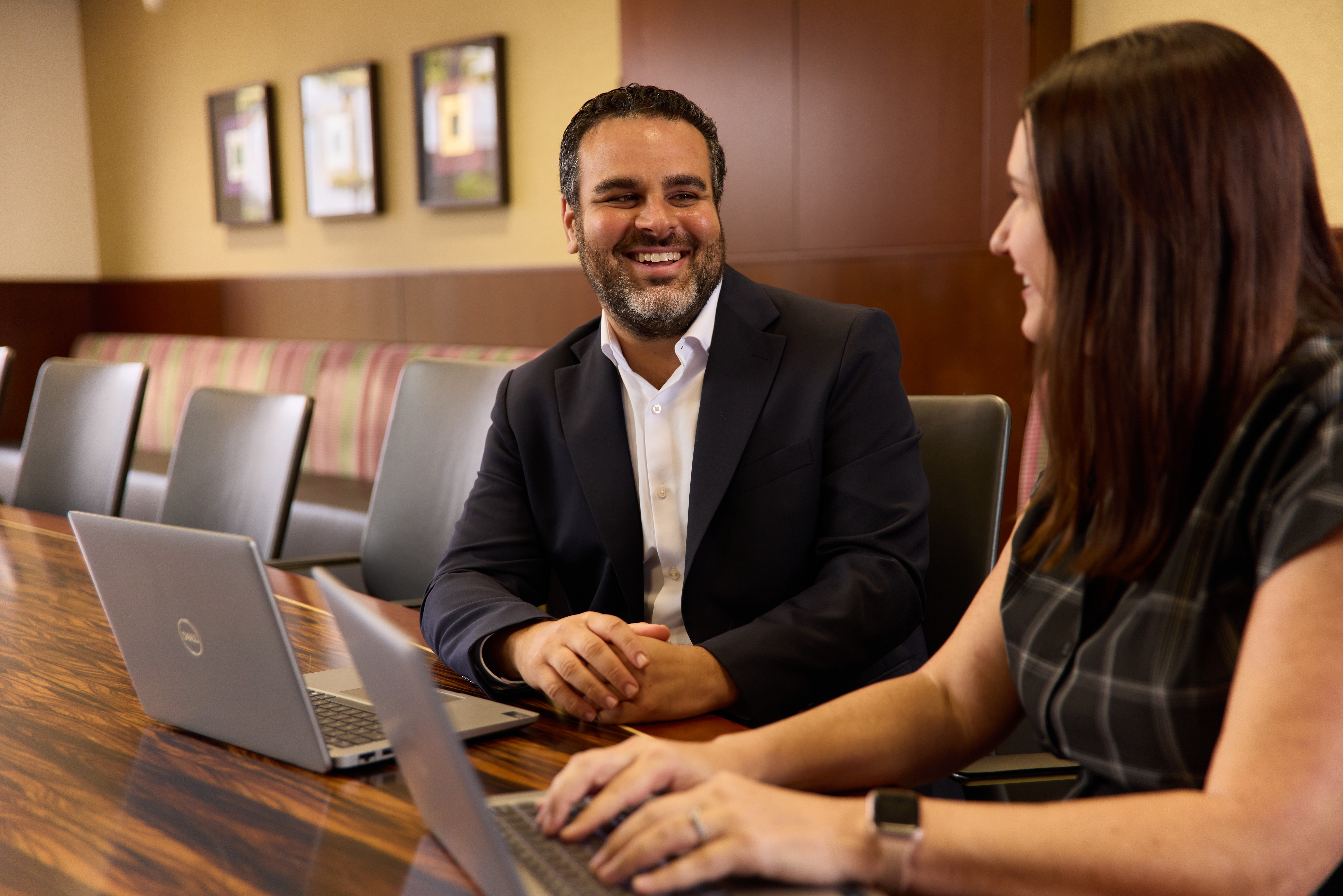 Two colleagues laughing at a table