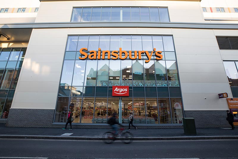 Image taken looking up at the front of a Sainsbury's store
